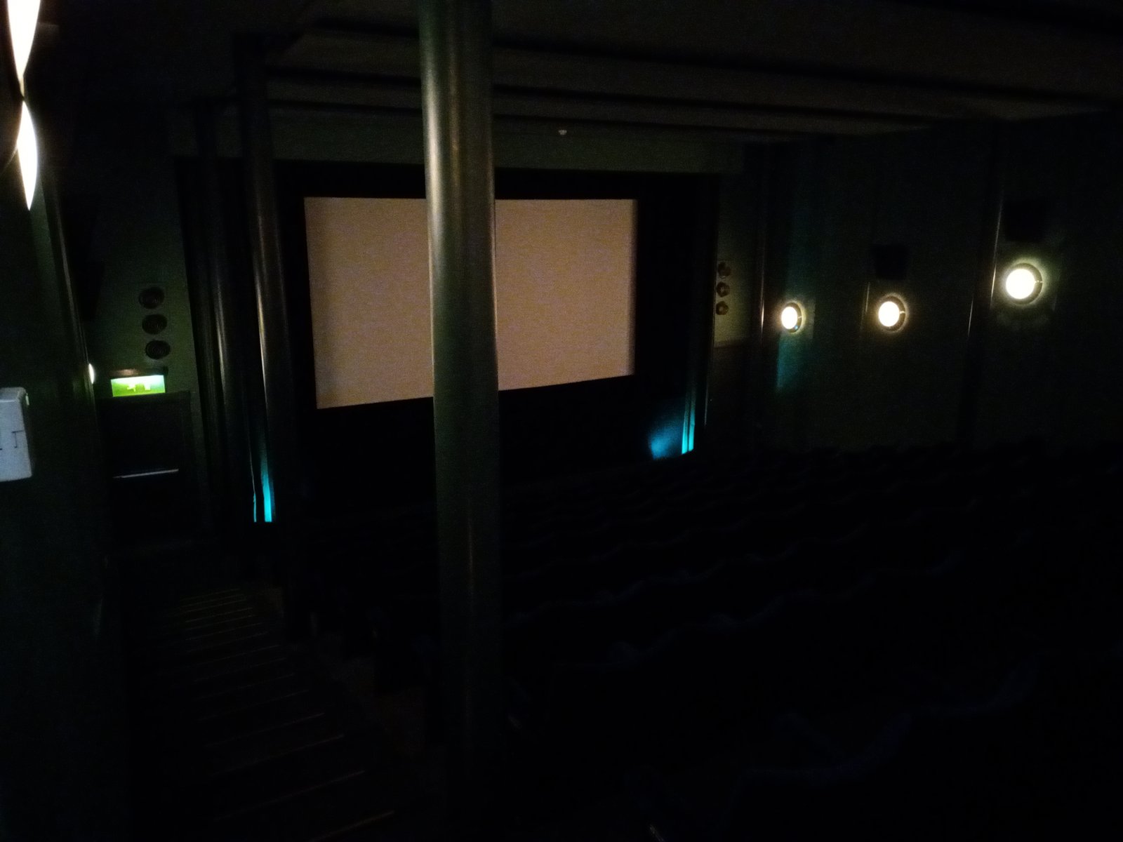 Interior of a movie theater with rows of seats facing the screen