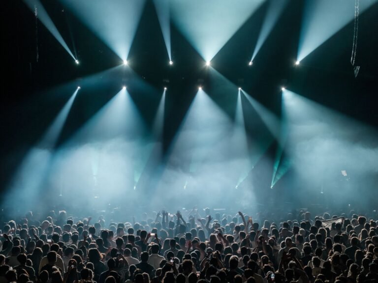 A vibrant concert crowd under dramatic stage lights