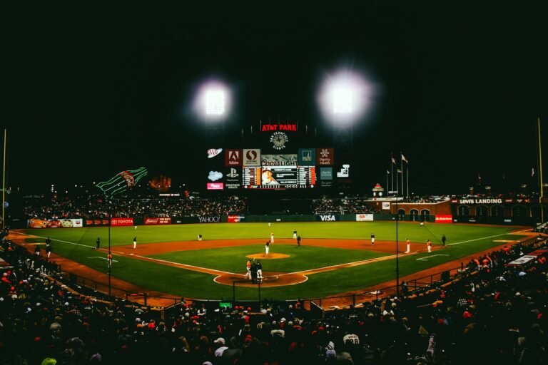 Baseball stadium at night with fans in the stands
