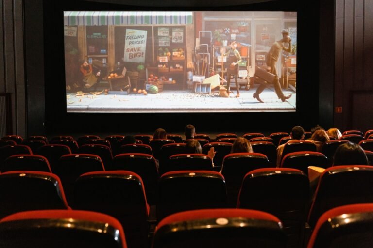 Movie theater audience watching an animated film, similar to the Pokemon: Wild Card 2027 movie announcement