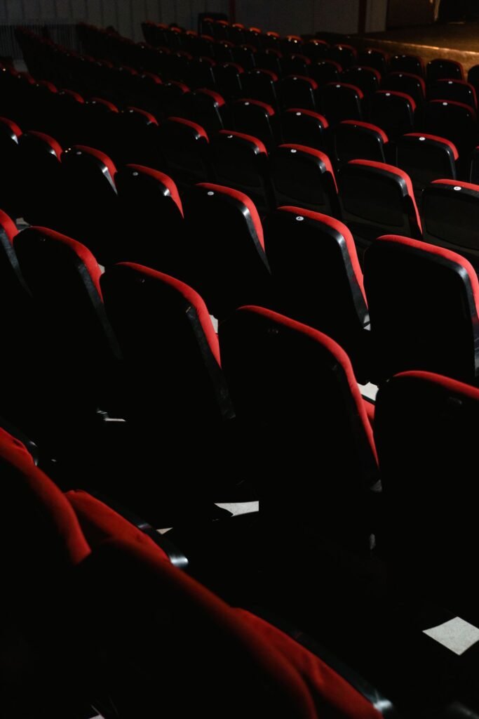 Rows of empty red cinema theater seats