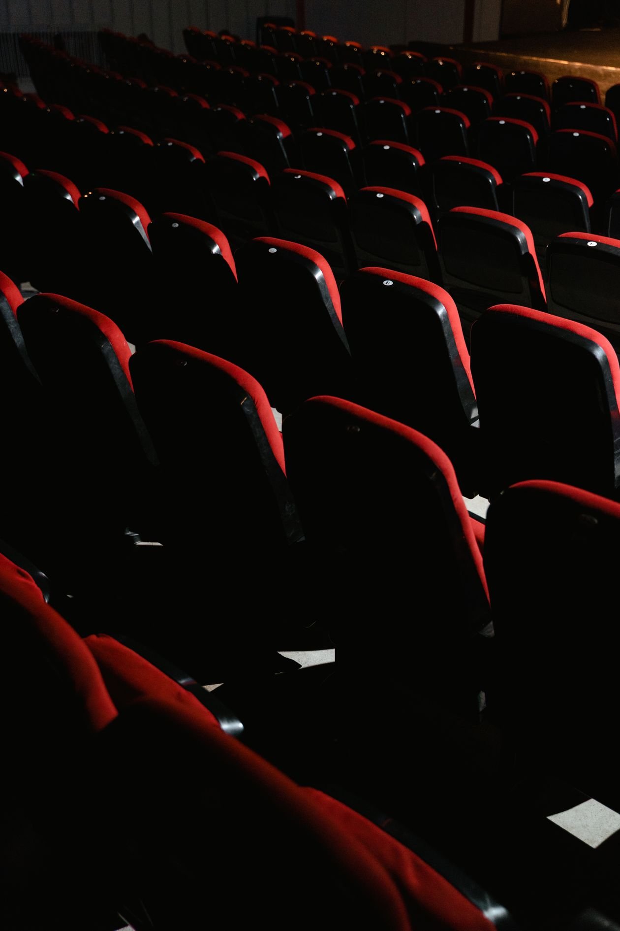 Rows of empty red cinema theater seats
