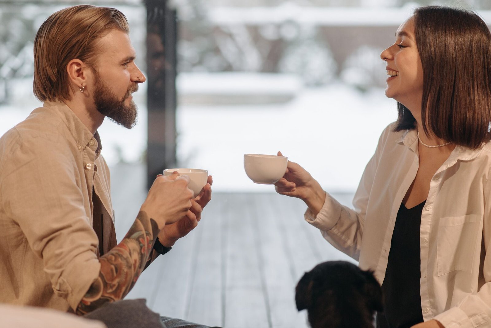 A couple smiling and talking over coffee