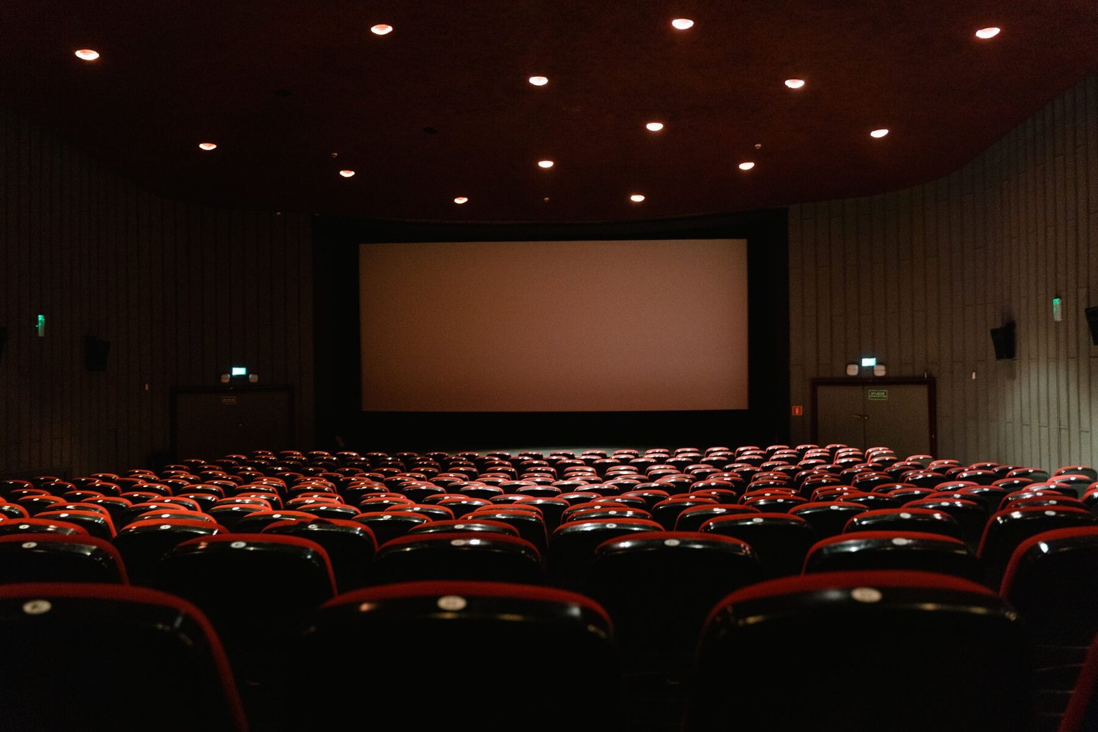 An empty movie theater with a large blank screen