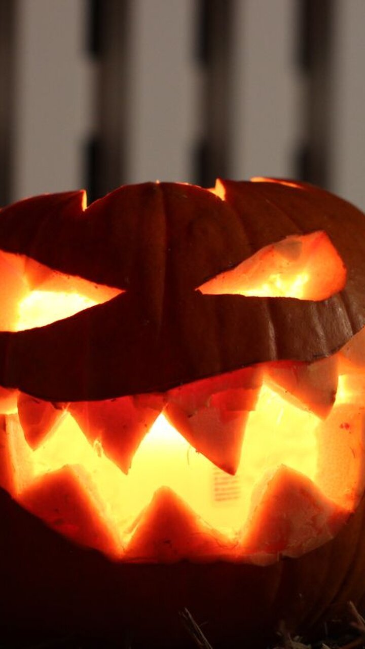 A glowing carved jack-o-lantern at night